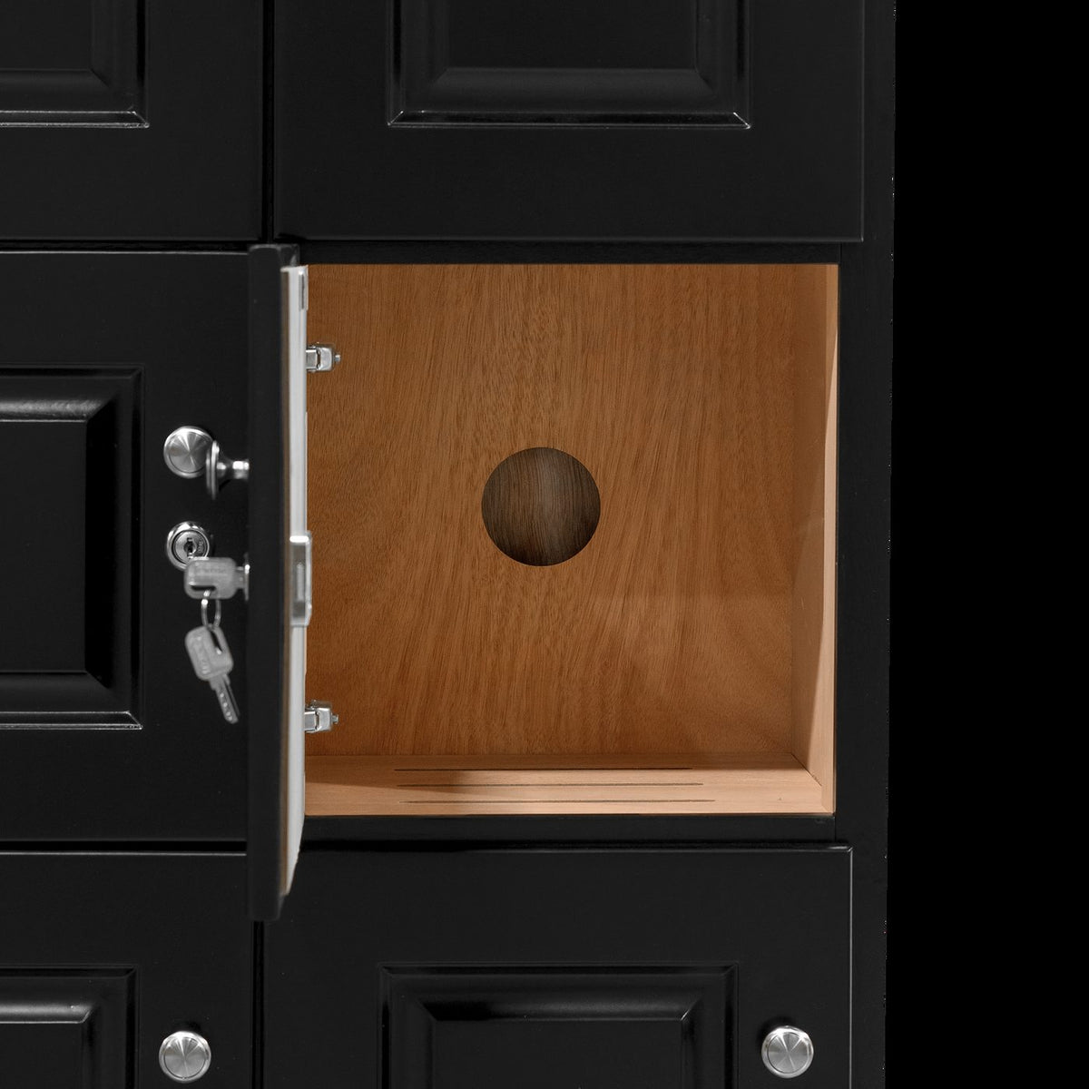 Open cigar locker with its key in the lock and Spanish cedar lining